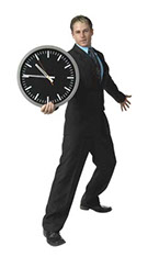 Photo of a man holding a clock.