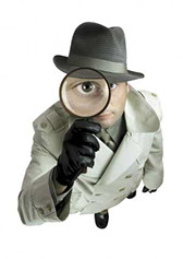 This is a photo of a detective holding a magnifying glass.